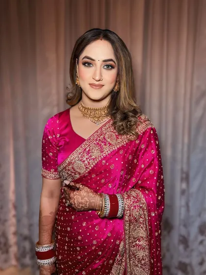 Reception ready in a beautiful pink saree. The makeup is classic and elegant, with a soft brown smokey eye and glowing skin.