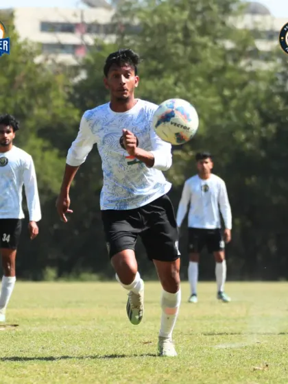 A player receiving the ball, showcasing good first touch and awareness of the players around them.