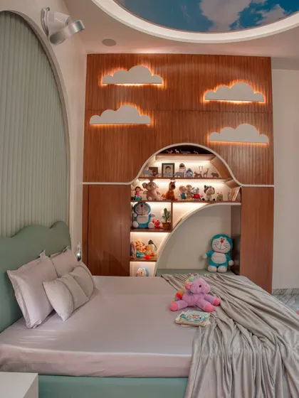 A close-up of the custom-built shelving and bed in the whimsical kid's room. The arched niche is perfect for displaying toys and treasures, with integrated lighting to highlight them.