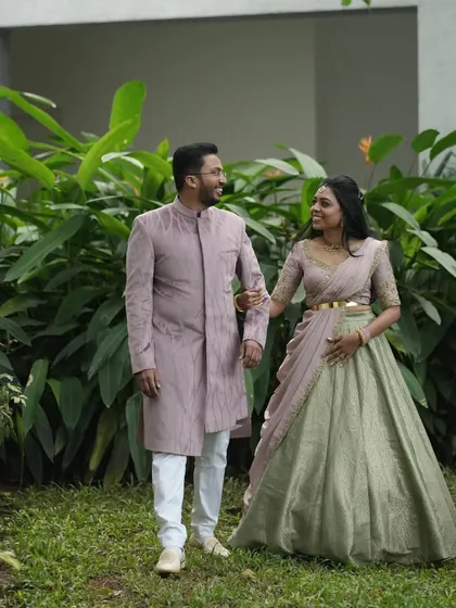I love creating coordinated looks for couples. Here, Dr. Tushara wears a custom pastel green and pink lehenga, and we designed a matching bandhgala for her partner to create a harmonious and elegant look for their event.