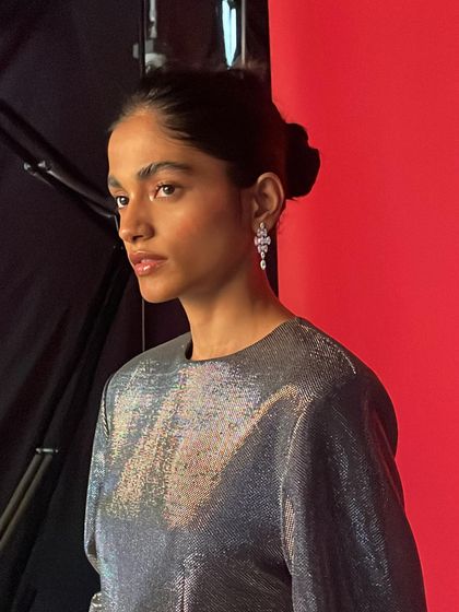 Another portrait from the same BTS series, capturing the model's profile and the elegant silver dress.