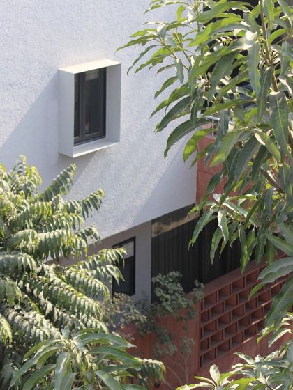A view of the Jaipur House through the trees, highlighting how the structure is thoughtfully integrated into its site. Our designs always seek to create a harmonious relationship with their surroundings.