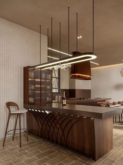 The dining and bar area at Siori Lily Villa combines modern design with a warm, cozy vibe. The sculptural bar, pendant lighting, and rich wood tones create a space that is both stylish and welcoming.