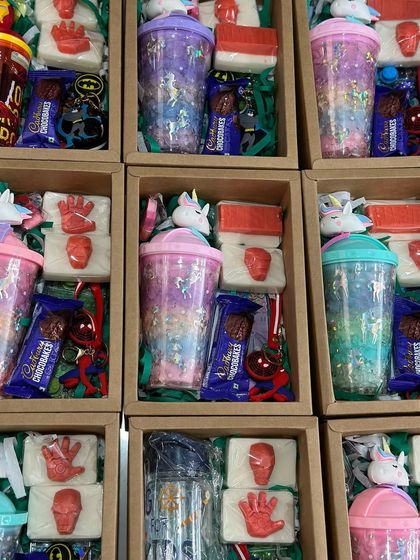 A look at our curated hampers for a party, mixing themes to please everyone. These boxes include Avenger-themed soaps, unicorn sippers, and other fun goodies.