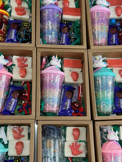 A curated hamper for kids, featuring Avenger soaps, a unicorn sipper, a water game, a keychain, and more.