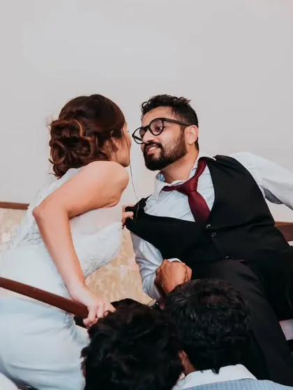 A playful moment during the reception, where the bride and groom are lifted on chairs for a traditional Jewish wedding dance, the Hora. We love capturing these unique cultural celebrations.