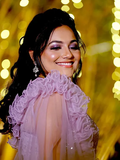 This bride radiated grace and elegance in her lavender-themed reception outfit. The glamorous makeup and soft hairstyle were the perfect complement to her stunning dress.