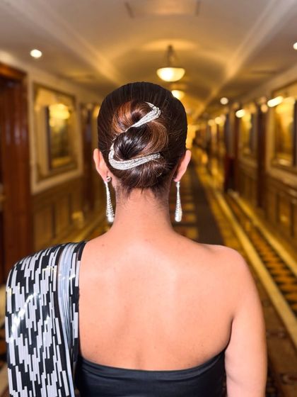 Another angle of the intricate snake bun. The clean lines and sparkling accessory make this a truly unique and glamorous hairstyle for a gown or saree.