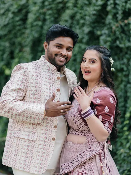 A fun, candid shot capturing the couple's excitement as they show off the new engagement ring, full of personality and joy.
