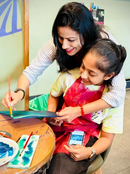A mother's loving guidance. A beautiful moment of connection and encouragement during our family-friendly workshop.