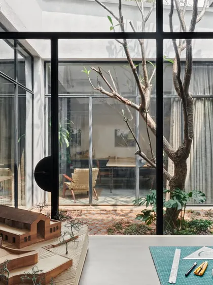 A view from our model room, looking through the courtyard into other office spaces. The use of large glass windows creates a sense of connectivity and transparency throughout the studio.