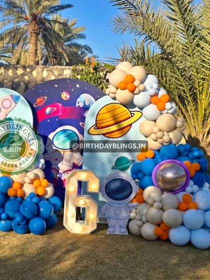 Another angle of the outdoor space party, showing the rocket ship panel and the full balloon arrangement.