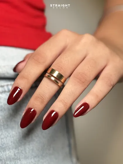 A classic, glossy red on perfectly shaped almond nails. This timeless look is always confident, bold, and polished.