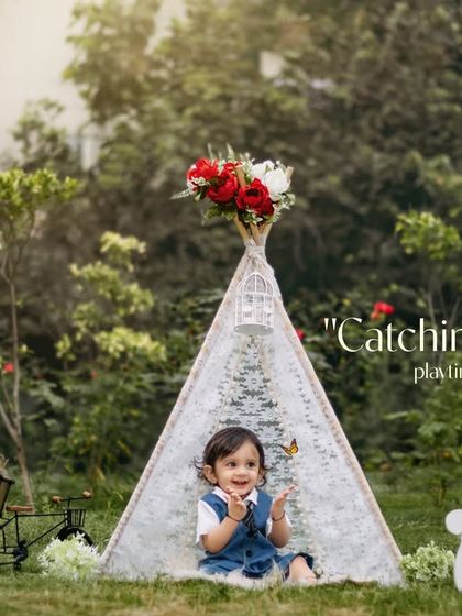 Catching dreams one playtime at a time. A sweet boy sits in a lace teepee during his outdoor photoshoot, capturing a moment of pure innocence.