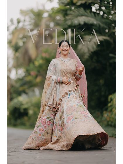 A joyful, twirling portrait of bride Vedika at her Goa wedding. This shot captures her vibrant personality and the beautiful flow of her floral lehenga, creating a feeling of light and happiness.