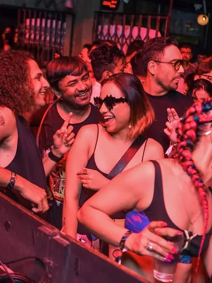 Friends vibing together by the DJ booth.