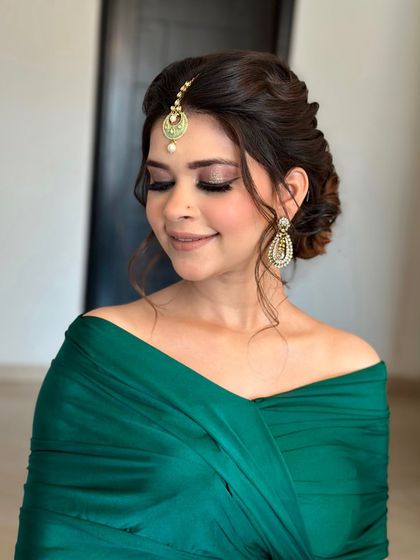 A festive and soft messy bun for a daytime event. I added a maang tikka and some floral accessories to create a look that is both traditional and effortlessly beautiful.