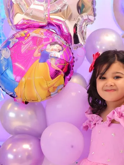 The birthday girl posing with her favorite princess balloons. We make sure to capture the little details and themes that make your child's party special.