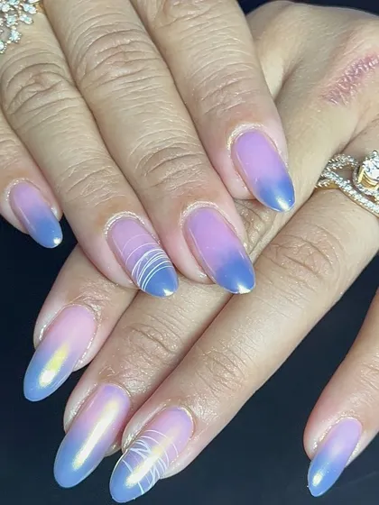 A full view of the stunning blue and pink chrome ombré nails.