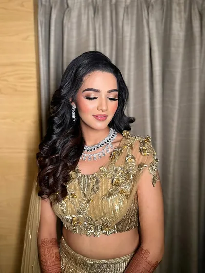 Painting the town fabulous with Mahek's sangeet look. This golden glam makeup features a warm, shimmery eye and glowing skin.
