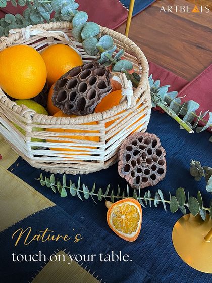 Nature is a constant inspiration for me, and I love bringing its elements to the table. This shot captures the tactile beauty of my khadi table runner alongside natural elements like oranges and lotus pods, highlighting the earthy aesthetic of the collection.