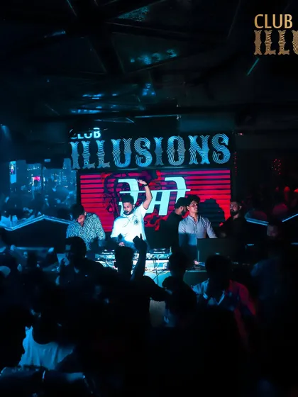A wide view of the stage at Club Illusions, with my name in lights. This shot establishes my presence as the main act of the night.