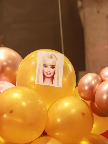 I can even customize the balloons with pictures, like this Barbie face on a gold balloon, to make the theme feel extra special.