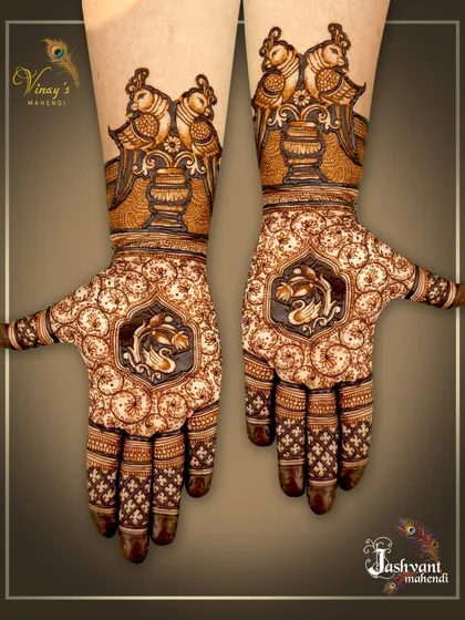 An intricate design with swans in the center of the palms and birds perched on pots at the wrists. The swirling background pattern is mesmerizing.