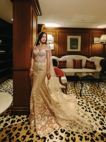 A full-length portrait of the bride in her exquisite gown. The intricate details of her dress and the luxurious setting reflect the sophisticated and elegant wedding we curated for her.