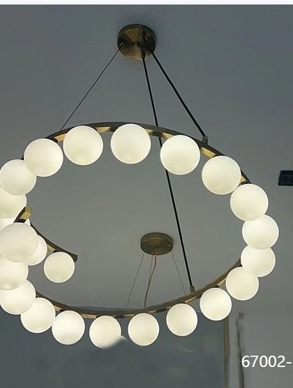 A modern spiral chandelier with frosted white globes. This design is perfect for a contemporary living room or dining area, offering a clean and stylish look.