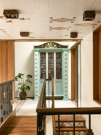 This custom bar cabinet was designed as a centerpiece for a landing. Inspired by Chettinad architecture, it features stained glass panels and a playful colour palette of mint green and ochre, making it a joyful and nostalgic statement piece.