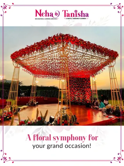 This is where vows are exchanged under a symphony of flowers. We designed this magnificent red floral mandap to stand out against the evening sky, creating a dramatic and romantic setting for a grand wedding ceremony.