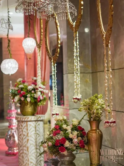 A detail of the entryway decor, showing the hanging floral tassels, ornate mirrors, and crystal elements. The combination of different textures and materials creates a rich and luxurious look.