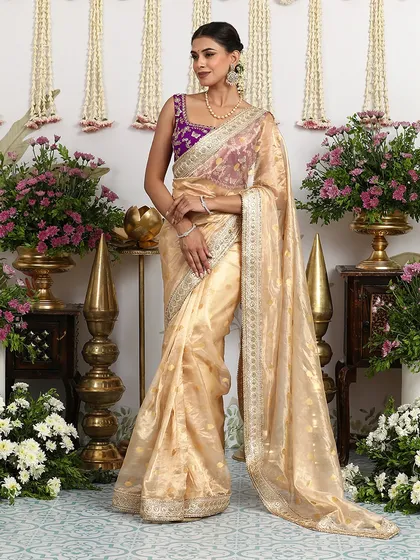 The elegant drape of the ivory organza saree is captured in this beautiful shot.