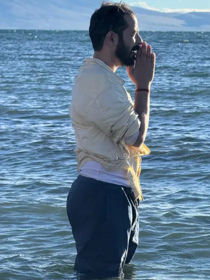 A close-up moment of prayer in the holy lake. The cold water is a shock to the system, but it awakens a deep sense of aliveness and connection.