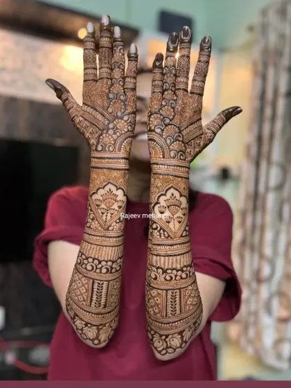 A full-arm design featuring intricate bands of traditional patterns, with a focus on floral and leaf motifs.
