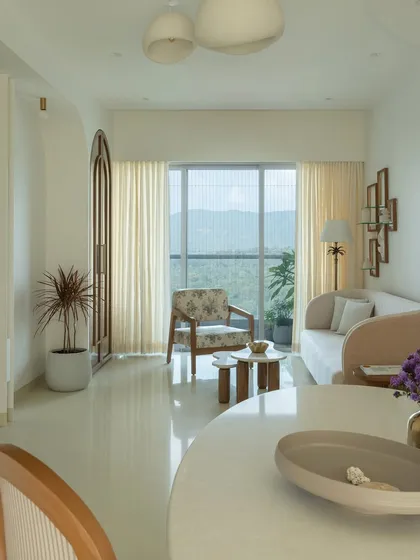 This living space embodies whitewashed serenity, designed as a peaceful retreat with stunning natural views. We used a soft, neutral palette and minimalist furniture to create an atmosphere of calm. The design prioritizes natural light, making the room feel airy and expansive.