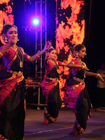 My dancers performing the 'Ayyappa Kavuthuvam' on a grand stage with a dynamic LED background, showing how we can adapt our classical art to modern event settings.
