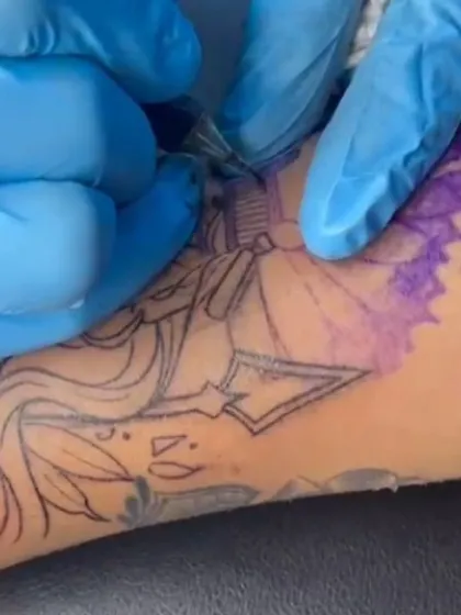 A close-up shot of the inking process for the illustrative forearm piece. You can see the stencil lines underneath as we carefully build the design.