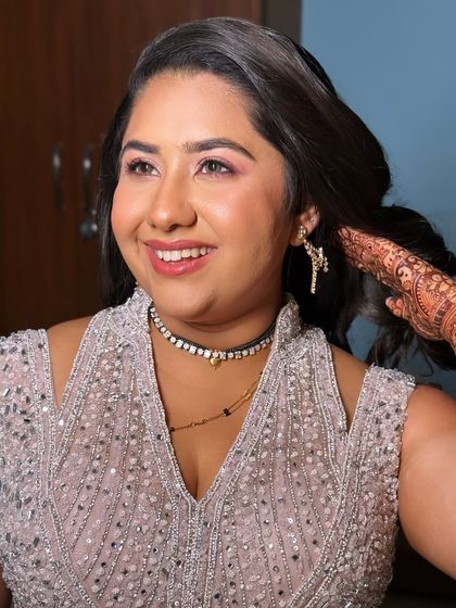 A happy, candid shot of this bride, her smile and the sparkle in her eyes are the main focus.