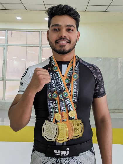 Ayaan showcasing his two gold, one silver, and one bronze medal from a stellar performance at the Delhi Open.
