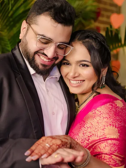 A sweet, intimate moment from an engagement ceremony. The bride's makeup is clean and glowing, perfect for a daytime sit-down lunch celebration.