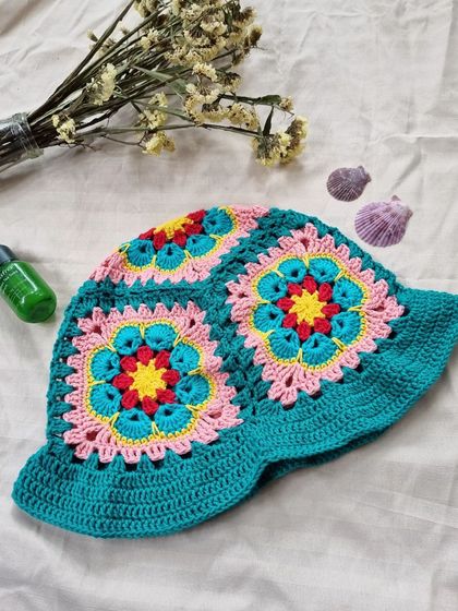 Our crochet bucket hat styled for a sunny day. It's a fun, handmade accessory that is sure to get compliments.