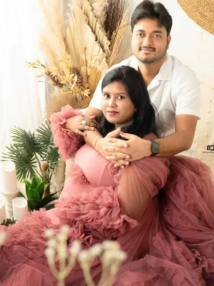 A cozy and intimate embrace on the studio couch. The soft textures and warm lighting create a comfortable setting for capturing your connection.