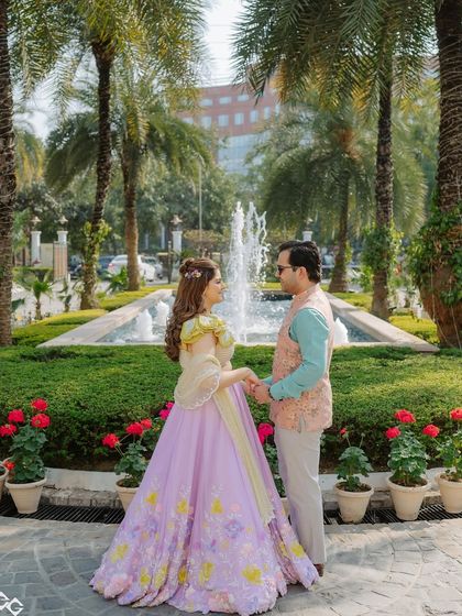 The full look in a beautiful garden setting. The pastel colors of her outfit and makeup look stunning against the lush greenery.