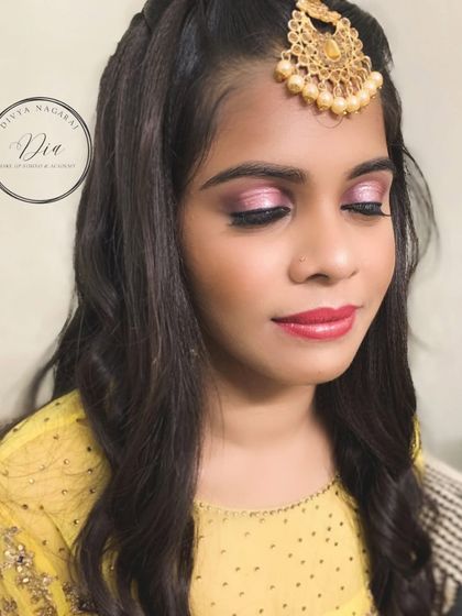 A pretty-in-pink look for her brother's wedding. This client is wearing a bright yellow outfit, so we opted for shimmery pink eyeshadow and a matching lip for a fun and youthful party look.