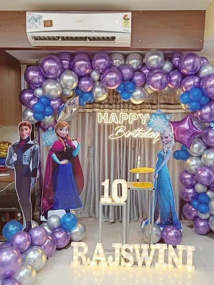 I bring popular themes to life for children's birthday parties. This Frozen-themed celebration includes a full balloon arch, character cutouts, and custom light-up lettering for the birthday girl's name.