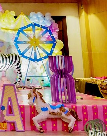 A detail shot of the carnival stage, showing a ferris wheel prop, a zebra, and a carousel horse.