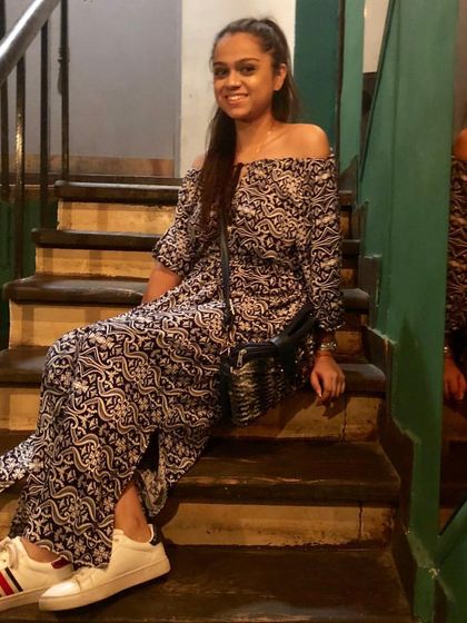 An off-shoulder printed maxi dress is the definition of effortless style. Paired with simple white sneakers, it's a comfortable yet fashionable outfit for a relaxed evening or a casual date night.