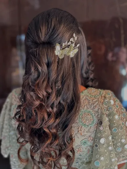 Soft, romantic curls with a half-up twist, accented with a beautiful butterfly clip. This hairstyle is versatile and works well for almost any special event.